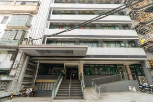 a building with a staircase in front of it at RedDoorz near Osmena Highway 1 in Manila