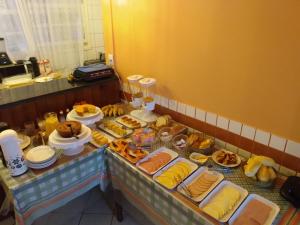 a buffet with many different types of food on a table at Pousada Cavaleiros in Macaé