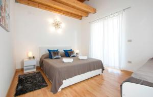 a bedroom with a large bed with blue pillows at Istriana house in Banjole +48 photos