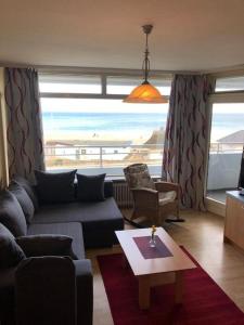 a living room with a couch and a table at Strandhotel Wohnung 33 in Dahme