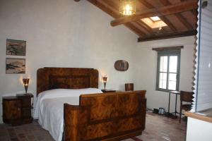 a bedroom with a wooden bed and a window at Il Gesuita in Mantova