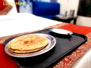 dos tortillas en una bandeja en una mesa en Luxmi Hotel, en Allahābād