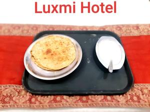 a pancake sitting on a tray with a computer mouse at Luxmi Hotel in Allahābād