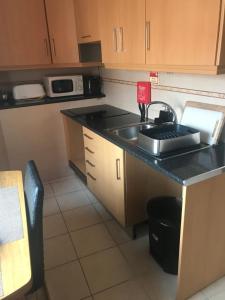 a small kitchen with a sink and a counter at Sun Place Guest House in Lagos