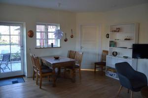 a kitchen and dining room with a table and chairs at Mosborg in Ulfborg