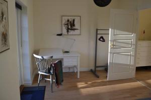 a room with a desk and a chair with a desk and a shelf at Mosborg in Ulfborg