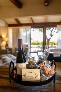 a bottle of wine and a glass on a table at Cnaan Village Boutique Hotel & Spa in Had Nes