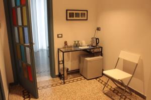 a room with a table and a chair and a refrigerator at CAMERA GIGLIA in Manarola