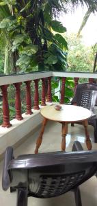 a table and a chair on a balcony at Casa De Olga in Vagator