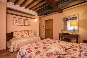 Postel nebo postele na pokoji v ubytování Relais Osteria Dell'Orcia