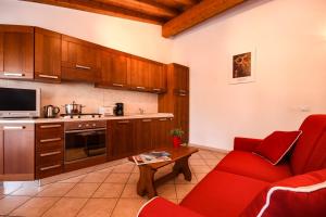 聖費利切德爾貝納科的住宿－Cappuccino，一间厨房,内设红色椅子和桌子