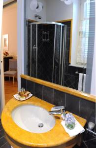 a bathroom with a sink and a shower at Ristorante Albergo Ca' Vittoria in Tigliole