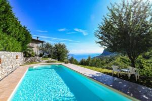 a swimming pool in a villa with a view of the ocean at Malga Mary in Tignale