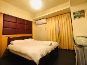 Postel nebo postele na pokoji v ubytování Love Feng Jia Apartment Hotel