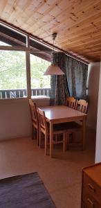 a dining room with a wooden table and chairs at Kolleviks Camping och Stugby in Karlshamn