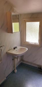a bathroom with a sink and a window at Kolleviks Camping och Stugby in Karlshamn