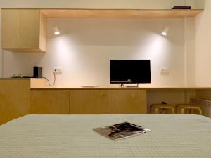 a bedroom with a bed and a television on a counter at Kolonaki Terrace in Athens