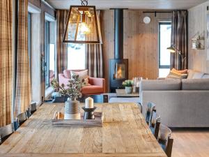 a living room with a wooden table and a couch at 10 person holiday home in F vang in Favang