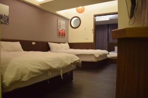 Postel nebo postele na pokoji v ubytování Love Feng Jia Apartment Hotel
