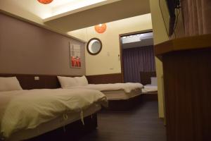 Postel nebo postele na pokoji v ubytování Love Feng Jia Apartment Hotel