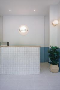 a white tiled counter in a room with a plant at Wynn House in Karon Beach