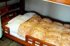 Voodi või voodid majutusasutuse Sakura Guest House toas