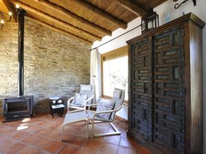 
a living room filled with furniture and a large window at Finca Las Abubillas in Jaraicejo
