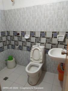 a bathroom with a toilet and a sink at Jay Henry Transient Beach house, B Pagudpud, BLUE LAGOON BEACH in Pagudpud