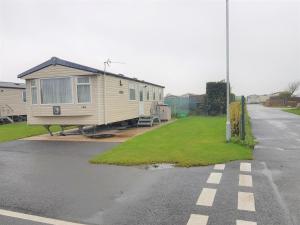a mobile home parked on the side of a road at 720 Holiday Resort Unity, Brean in Brean