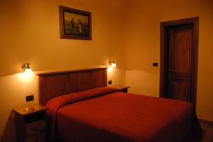 a bedroom with a bed and two lights on the wall at Hotel Margaret in Florence