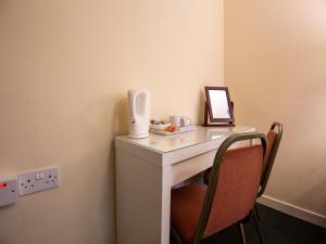 
a desk with a laptop and a chair at Longforgan Coaching Inn in Dundee
