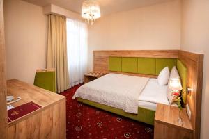 Łóżko lub łóżka w pokoju w obiekcie Grein Hotel