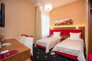 Łóżko lub łóżka w pokoju w obiekcie Grein Hotel