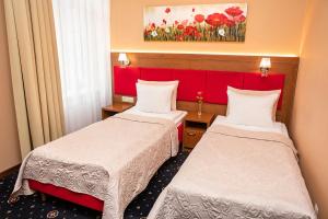 Łóżko lub łóżka w pokoju w obiekcie Grein Hotel