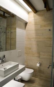 a bathroom with a white toilet and a sink at Haraki Blue Pearl Luxury studio in Haraki +24 photos