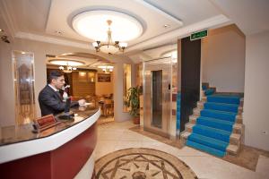 a man standing at a counter in a hotel lobby at Hotel Bulvar Istanbul in Istanbul