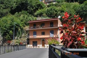 a house on the side of a road with a fence at VICO EQUENSE B&B 40 Steps in Vico Equense