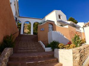 a house with stairs in front of it at Apartment with Panoramic Views, San Juan de Capistrano, Nerja in Nerja