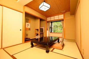 a living room with a table and a window at Hoshokaku in Takayama