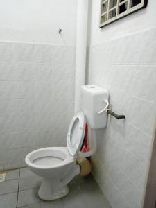 a bathroom with a toilet with the lid up at Muslim Homestay Ustaz 2 in Taiping