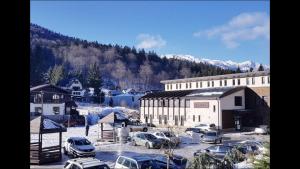 a parking lot with cars parked in front of a building at Purple Suite in Sinaia
