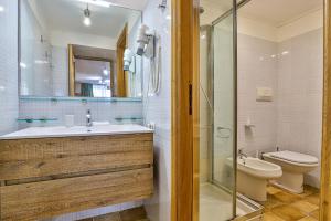 a bathroom with a sink and a toilet and a shower at Cervinia Apartment in Breuil-Cervinia +34 photos