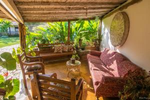 a living room with a couch and chairs at Casa de Violeta Pousada in Tiradentes