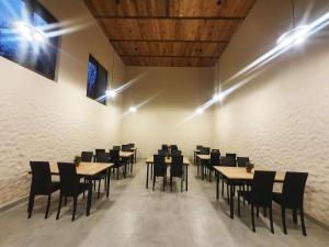 a dining room with tables and chairs and lights at Taba Hall Boutique Hotel in Akhaltsikhe