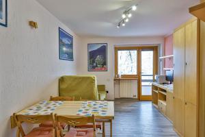 a kitchen and dining room with a table and chairs at Cervinia Apartment in Breuil-Cervinia
