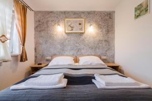 a bedroom with a bed with two pillows on it at Ośrodek Wypoczynkowy Cypel in Polańczyk