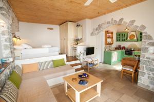 a living room with a couch and a table at Petra Boutique Homes in Aryinónda