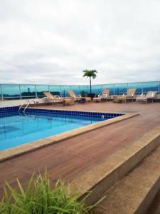 a swimming pool on the roof of a building at Mirante Flat in Ouro Branco