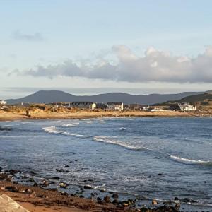 a beach with a group of houses in the distance at Surfers Getaway - Room Staycation in Sligo