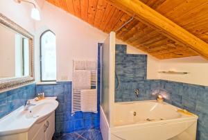 a bathroom with a tub and a sink at Villa Lieta in Ischia +155 photos